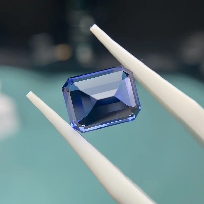 Emerald Cut Royal Blue Lab Grown Sapphire back view on a tweezer